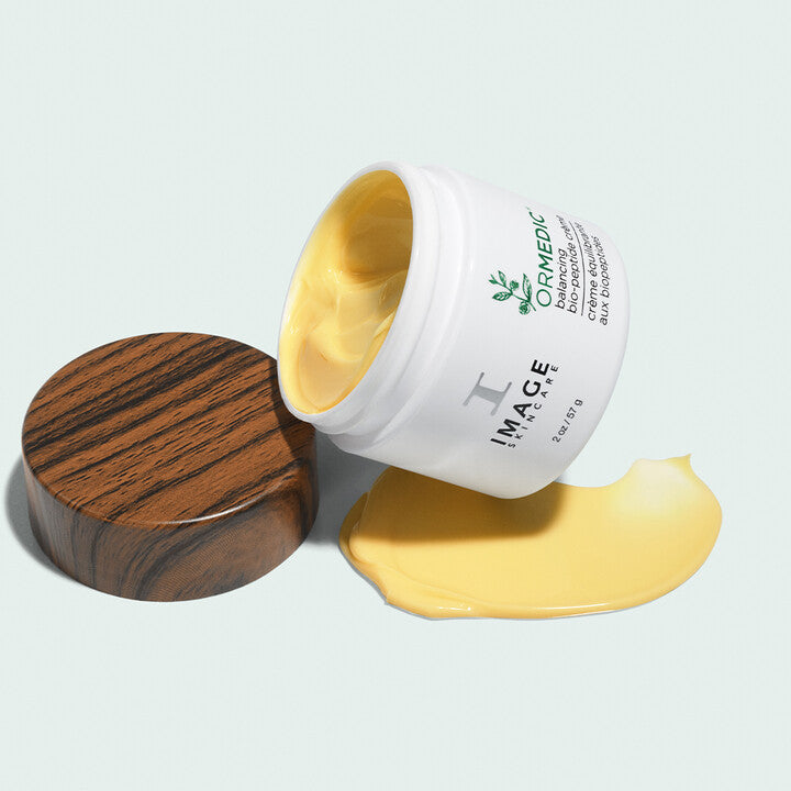 ORMEDIC Balancing Biopeptide Crème open bottle with swatch